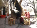 Close to Teloutet, woman cooking bread