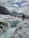 A river by melting ice disappears in this huge hole in the ice, Aletsch Glacier, Swiss